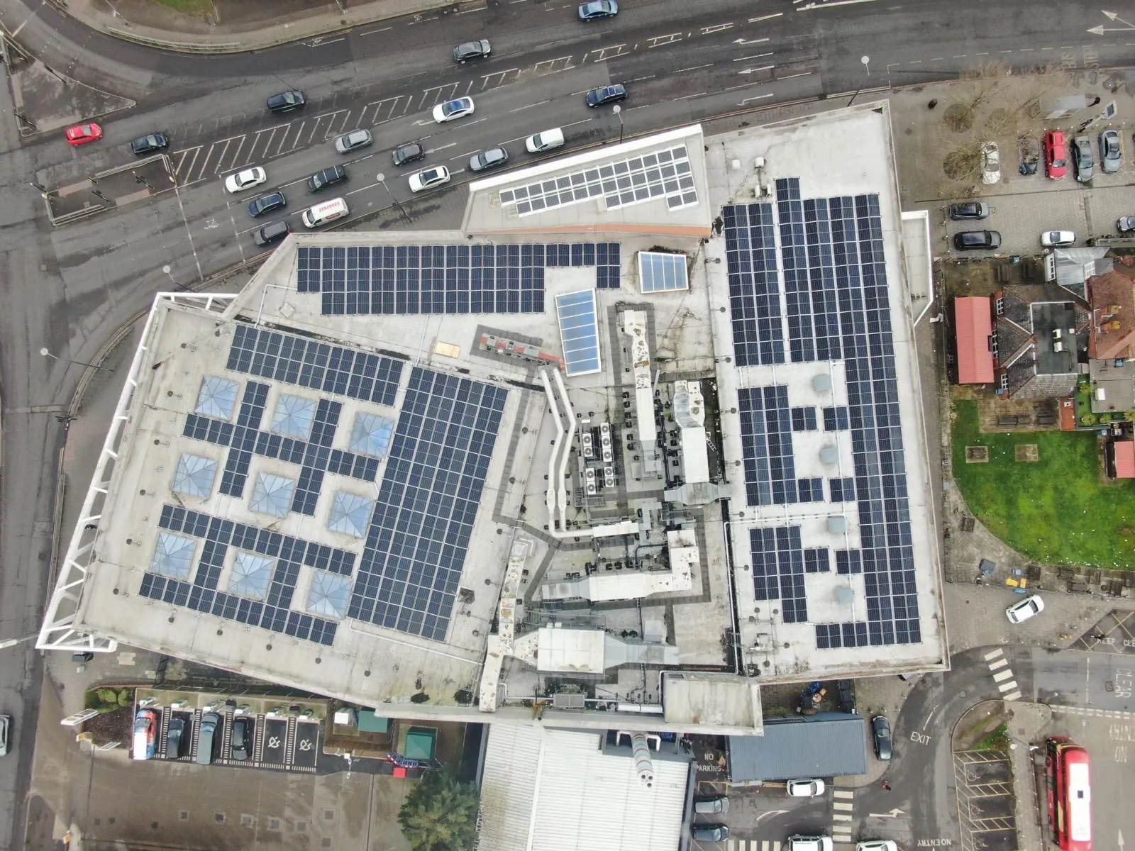 Large commercial rooftop solar array installed on a retail building